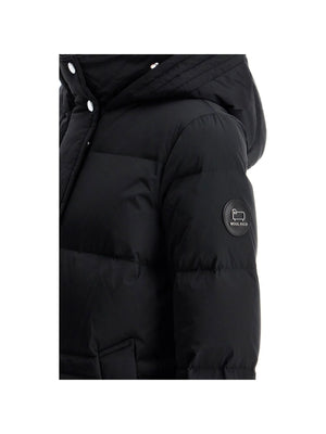 Black puffy quilted midi down jacket featuring a prominent brand logo patch